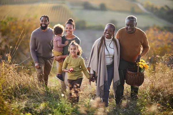 Three generations of a family walking together outdoors